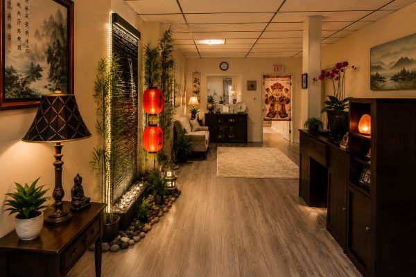 Warm and welcoming interior of Fairhaven Healing Spa featuring Chinese-inspired decor, bamboo, lanterns, plants, and a relaxing reception area.